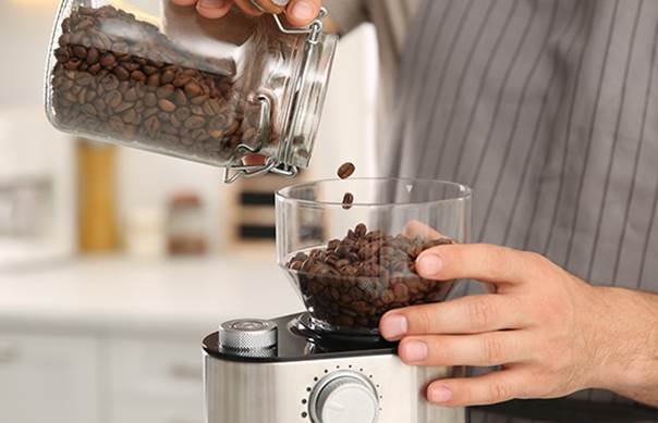 تصویر ریختن دانه قهوه باکیفیت به درون دستگاه